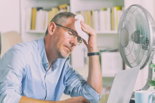 Man Cooling Off With Fan 641x426 1