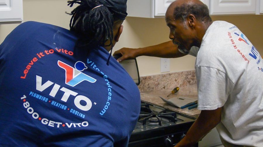 Vito employees inspecting gas range during gas line service.