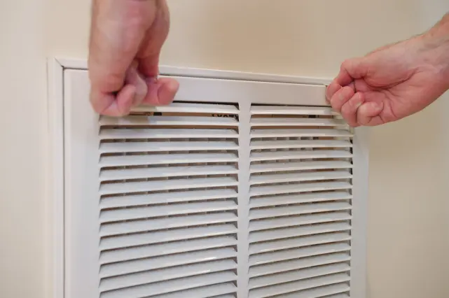 Person Cleaning Air Vent 641x426 1